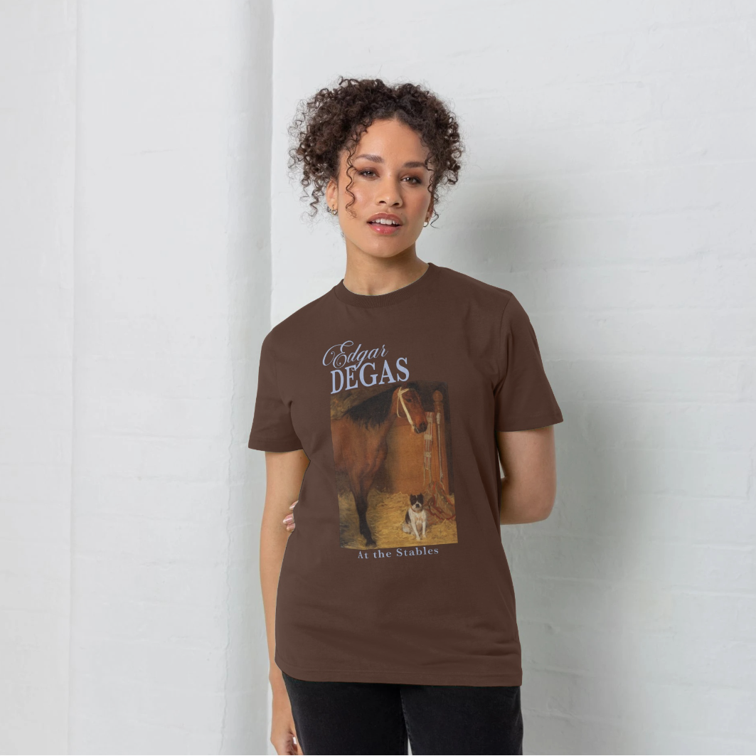 Person wearing a brown t-shirt with a graphic design on a plain background