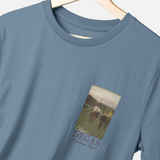 Blue t-shirt with a graphic of horses and 'Edgar Degas' text on a hanger.